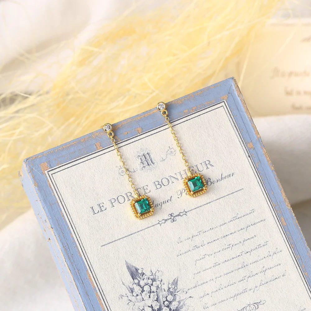 Emerald drop earrings with long gold plated chains