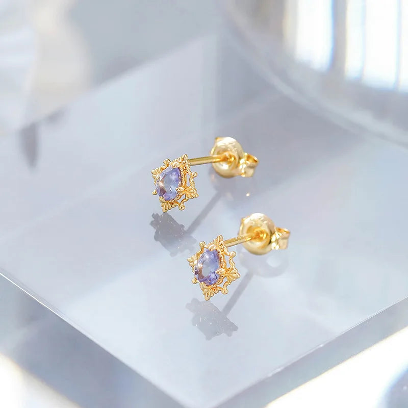 Tanzanite stud earrings shown from an angled view with gold plated setting