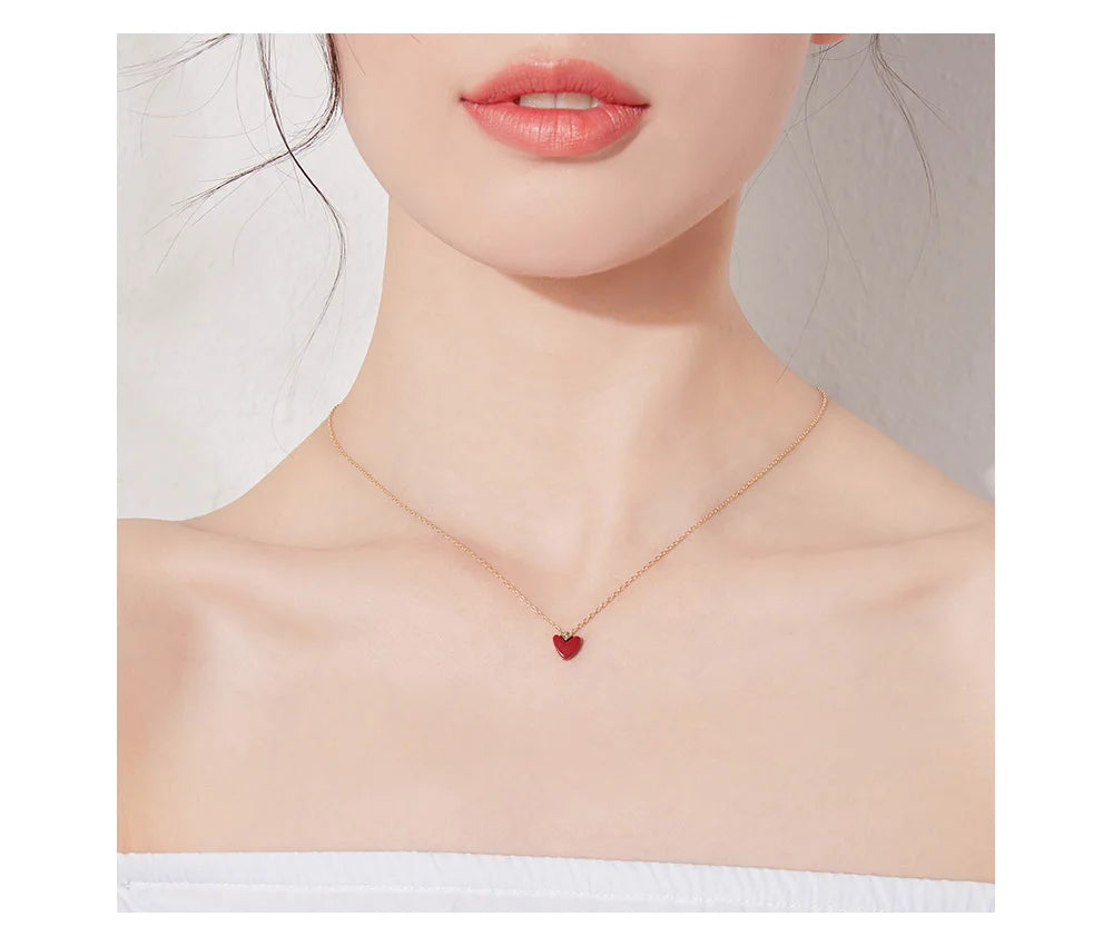 Close-Up of Red Coral Heart Pendant with Elegant Gold-Plated Design