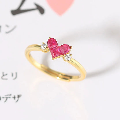 Close-up of Ember ring with heart-shaped red corundum stone and gold setting