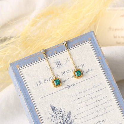 Emerald drop earrings with long gold plated chains