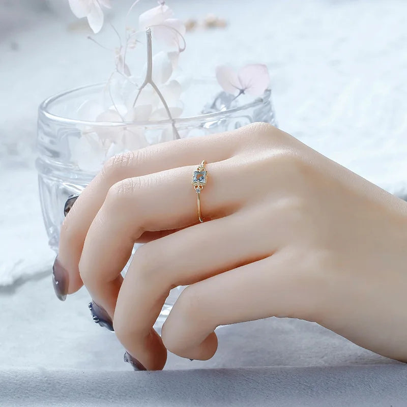 Aquamarine ring worn on finger with 14K gold plated setting