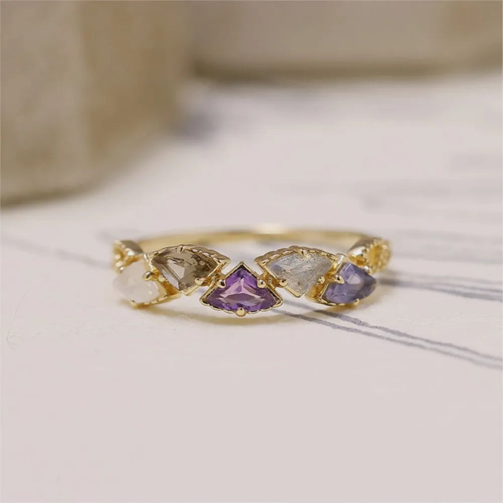 natural multi-stone ring displayed on jewelry stand