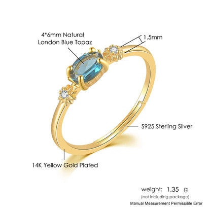 Gold ring with blue gemstone and text detailing material and weight on a white background