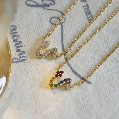 colourful serpent pendant necklace displayed with jewelry