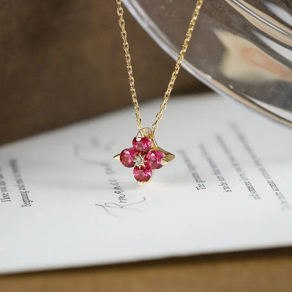 Red ruby four-leaf clover pendant on gold plated sterling silver chain