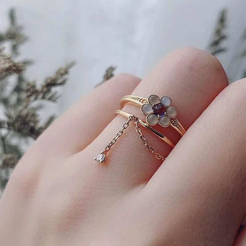 Natural iolite and agate flower ring worn on finger