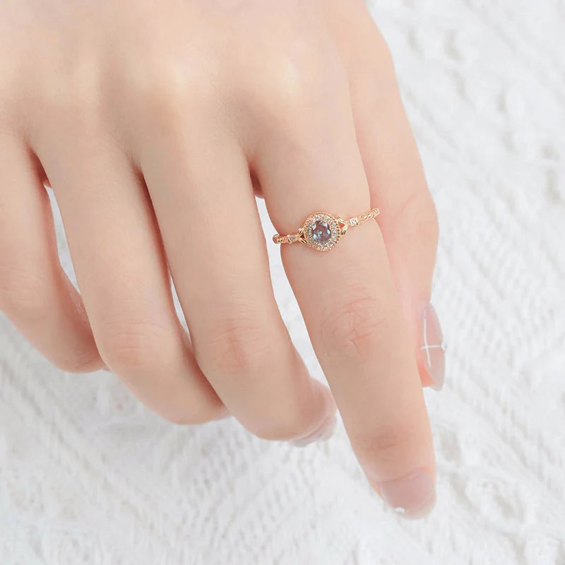 Lab-created alexandrite ring worn on hand in 14K gold plated silver