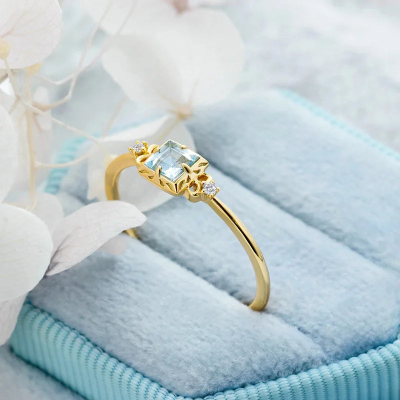 Natural aquamarine ring displayed on blue fabric