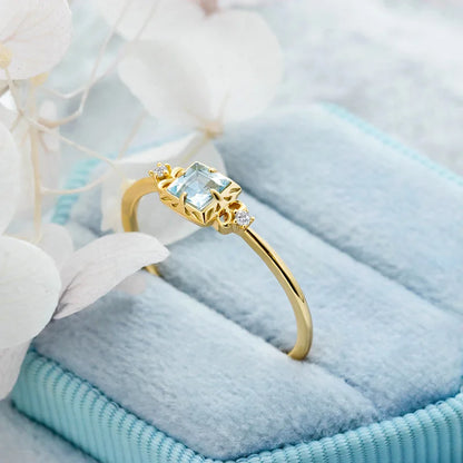 Natural aquamarine ring displayed on blue fabric