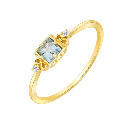 Gold ring with a rectangular gemstone and small diamonds on a white background