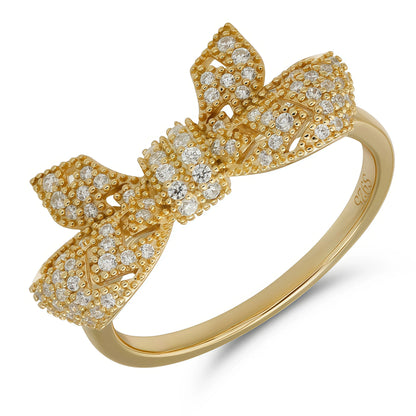 Gold bow-shaped ring with diamond accents on a white background