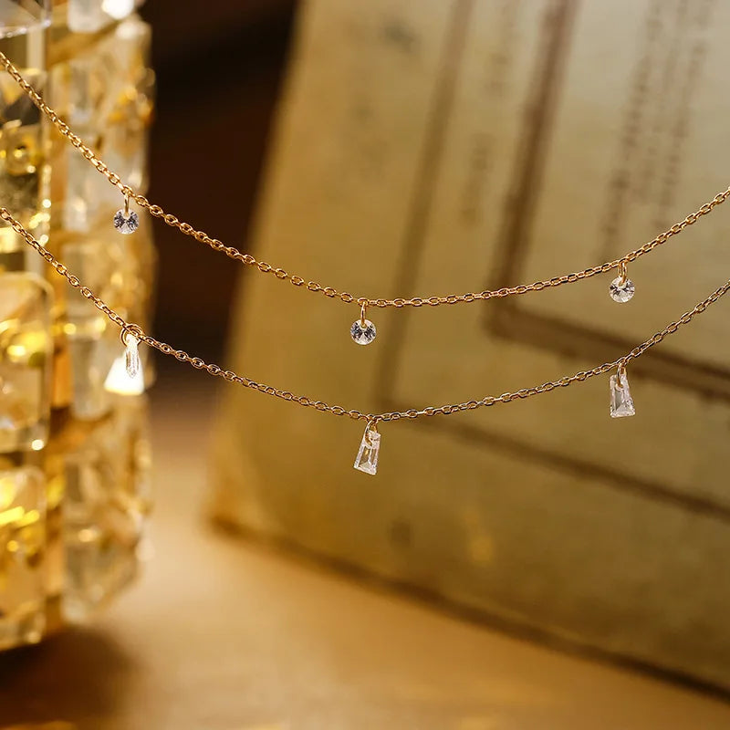 Delicate 925 silver chain necklace with small pendants on a blurred background