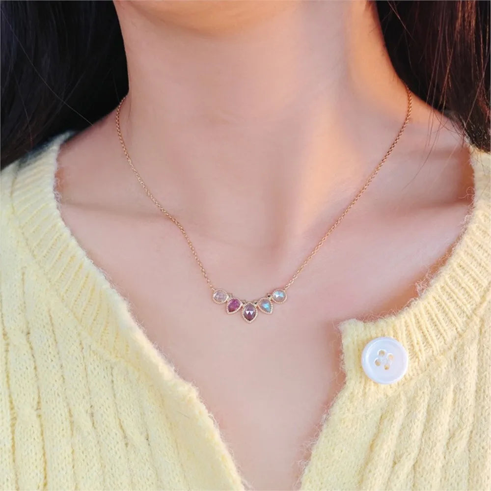 Multi-stone gemstone pendant necklace worn on a model