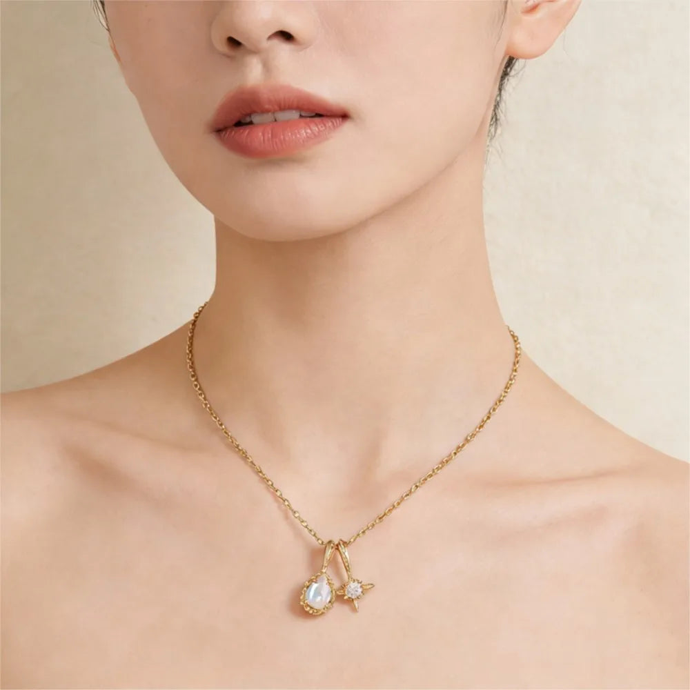Natural moonstone necklace with teardrop and star pendants worn on neck