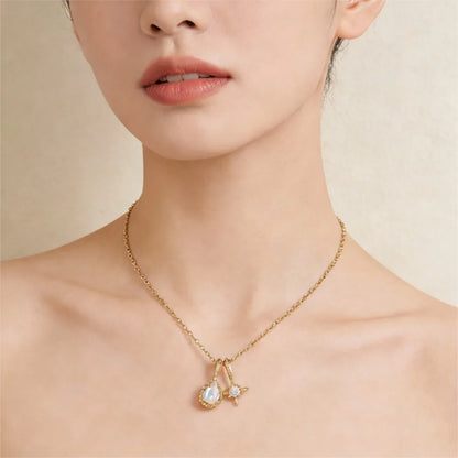 Natural moonstone necklace with teardrop and star pendants worn on neck