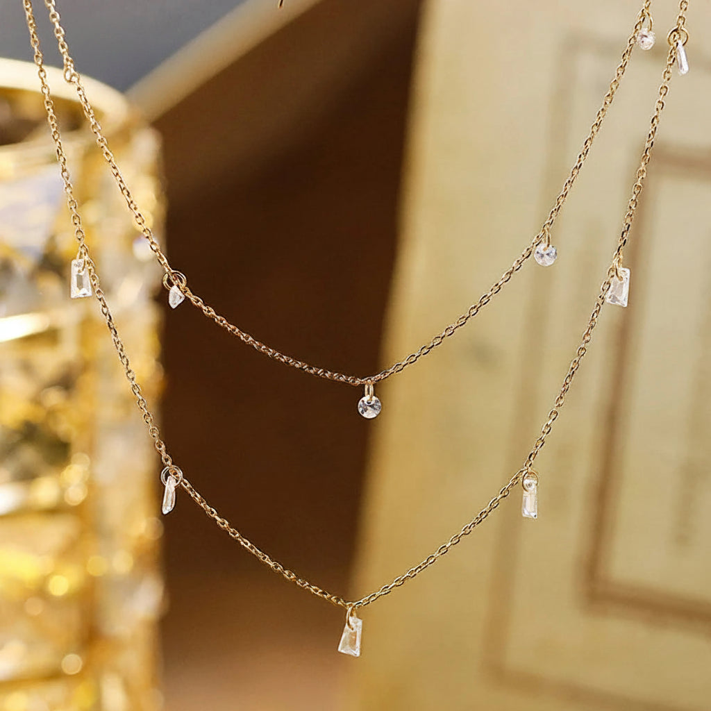 Gold necklace with small pendants on a blurred background,