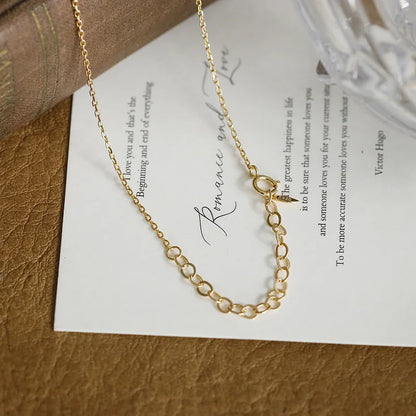 Lab-created ruby clover necklace displayed on a book