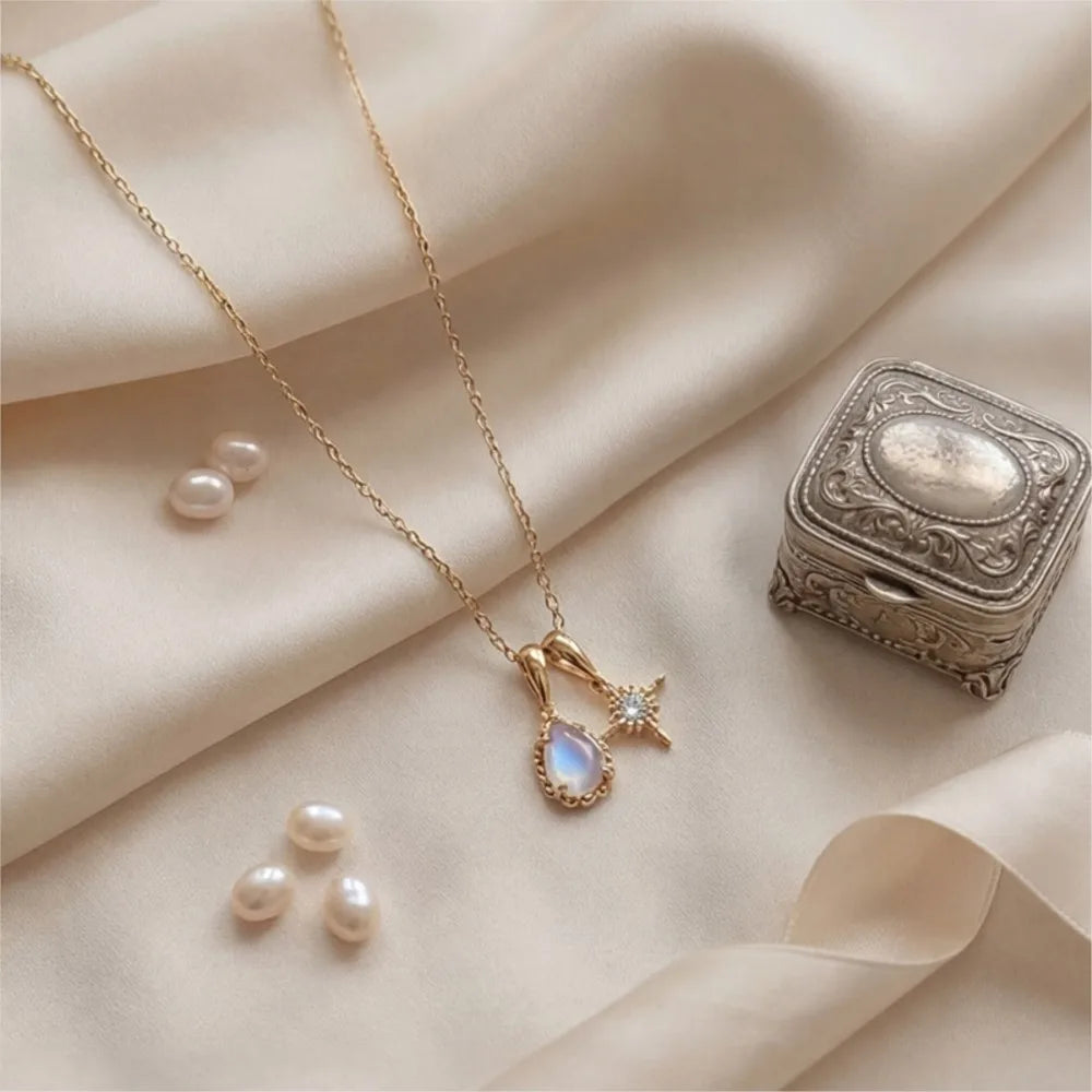 Natural moonstone double pendant necklace displayed on fabric