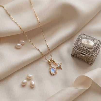Natural moonstone double pendant necklace displayed on fabric