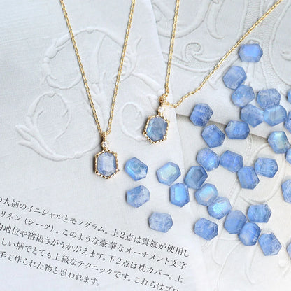 Natural moonstone necklace with synthetic sapphire accents displayed with blue stones
