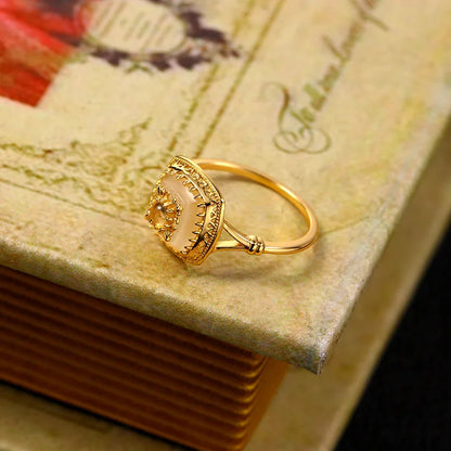 Natural chalcedony vintage ring displayed on an antique book