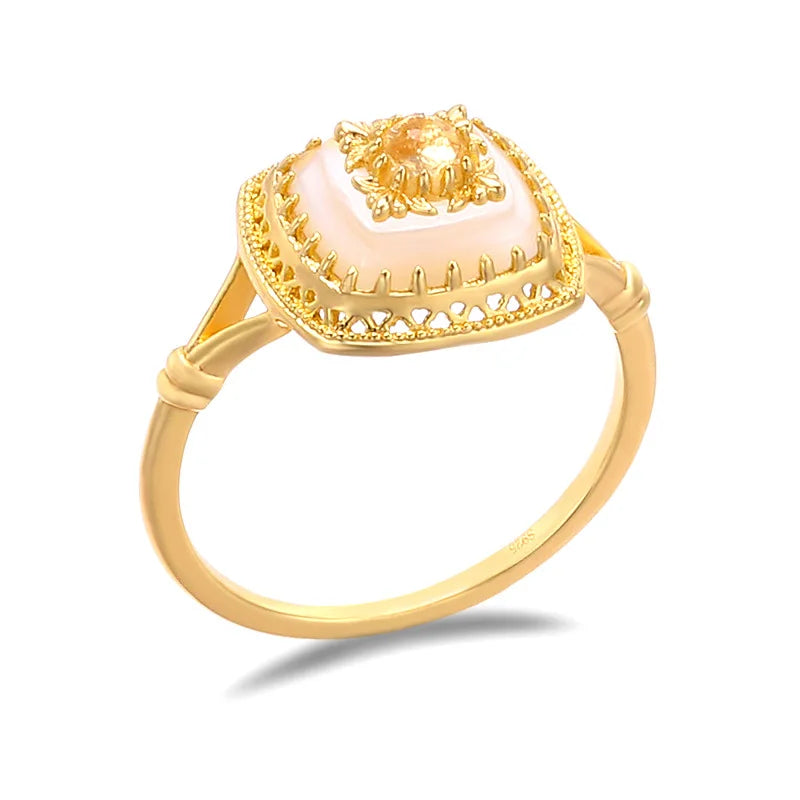 Close-up of natural chalcedony square ring with carved palace-inspired gold setting