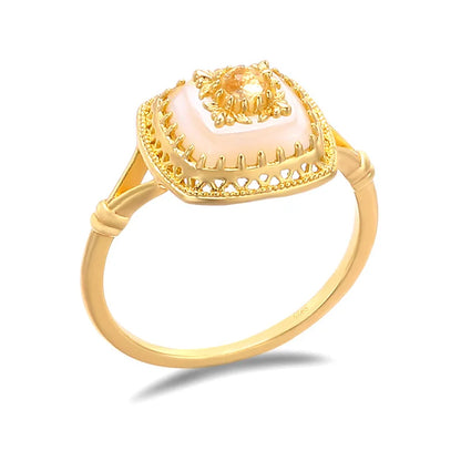 Close-up of natural chalcedony square ring with carved palace-inspired gold setting