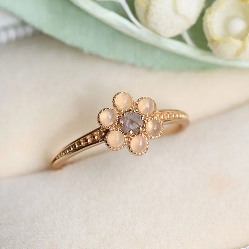 Natural iolite and agate flower ring with violet-blue stone and gold petals