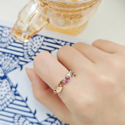 multi-stone gemstone ring worn on hand with purple and blue stones