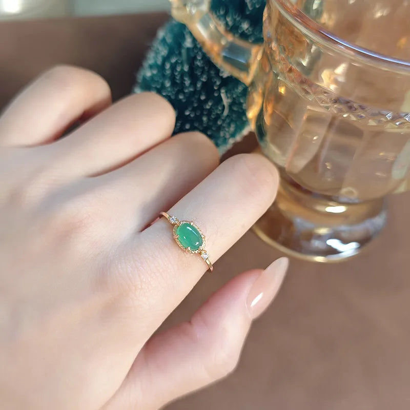 Natural green chalcedony oval ring worn on finger with gold plated setting