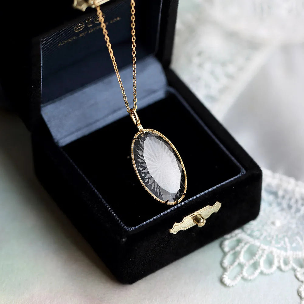 white crystal oval pendant necklace displayed in jewelry box