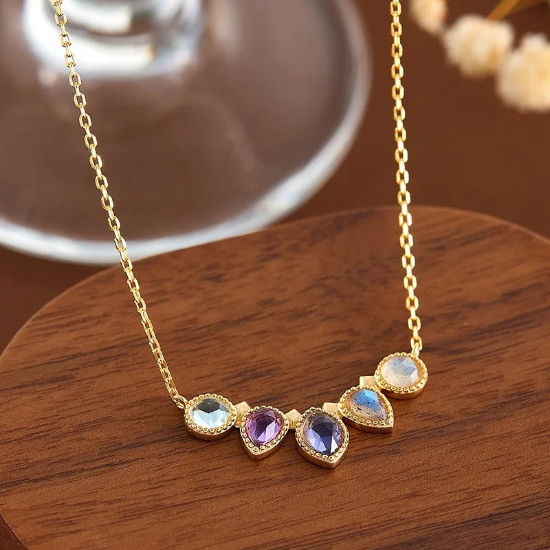 Close-up of natural amethyst, cordierite, topaz and labradorite pendant necklace