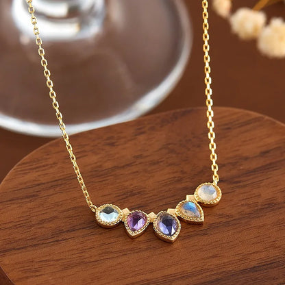 Close-up of natural amethyst, cordierite, topaz and labradorite pendant necklace