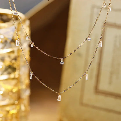 Silver necklace with small pendants on a blurred background