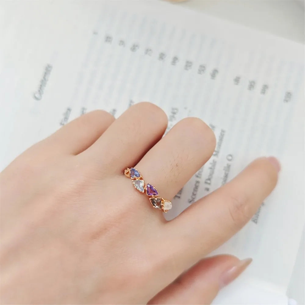 natural gemstone ring with purple and blue stones worn on finger