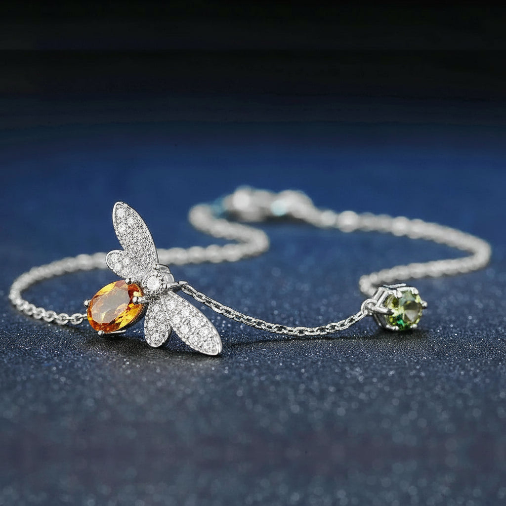 Silver bracelet with gemstones on a dark blue background.