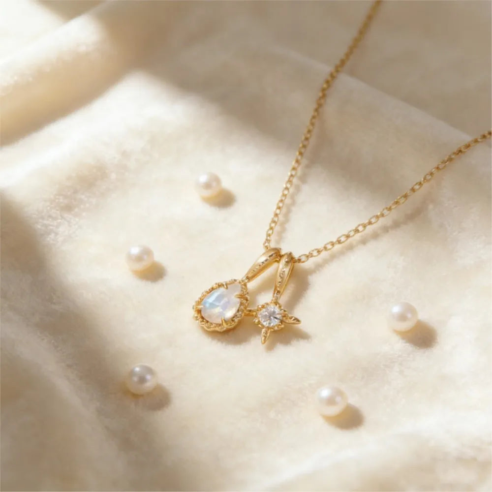Gold vermeil moonstone necklace displayed with jewelry and pearls