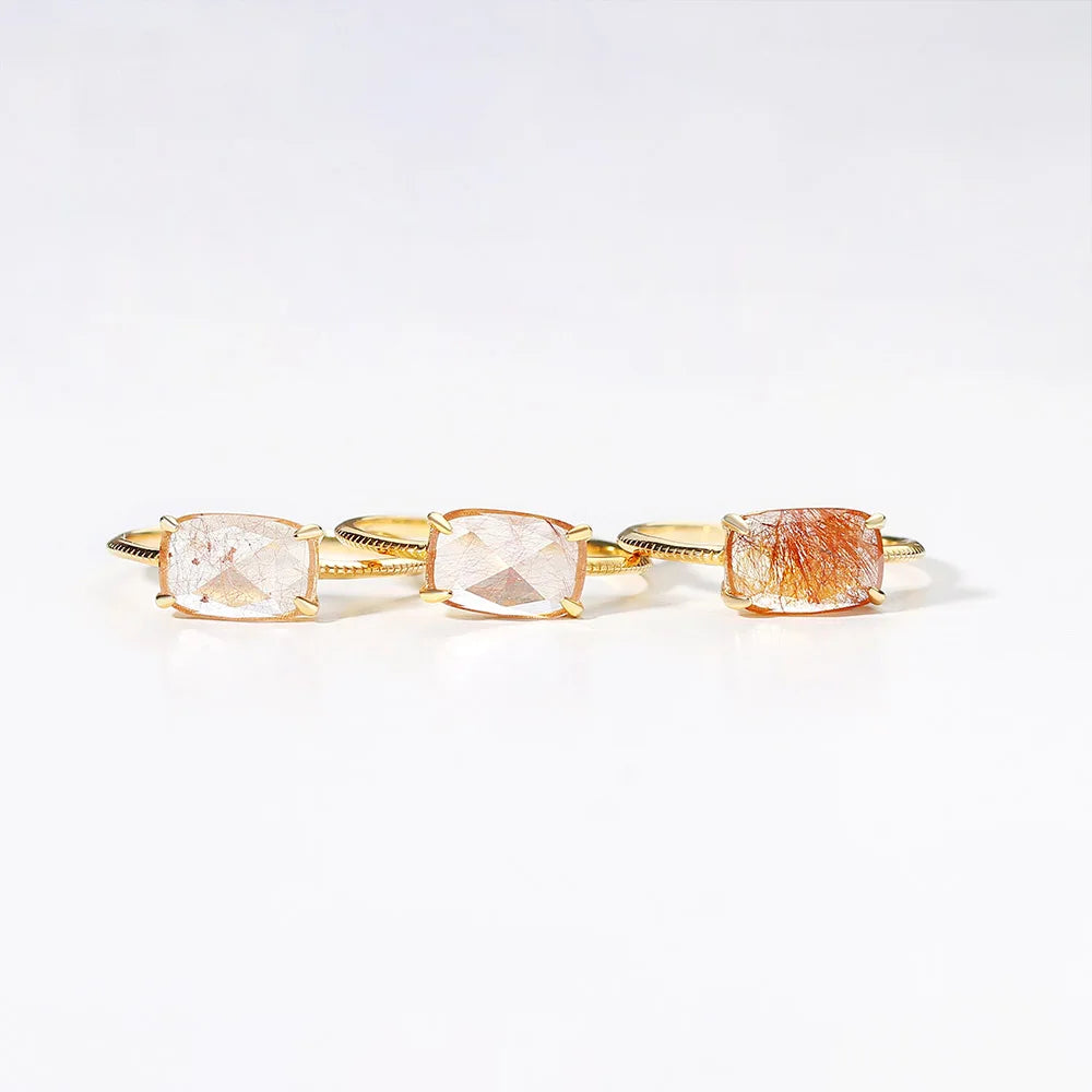 Quartz Rings with three different colored gemstones on a white background