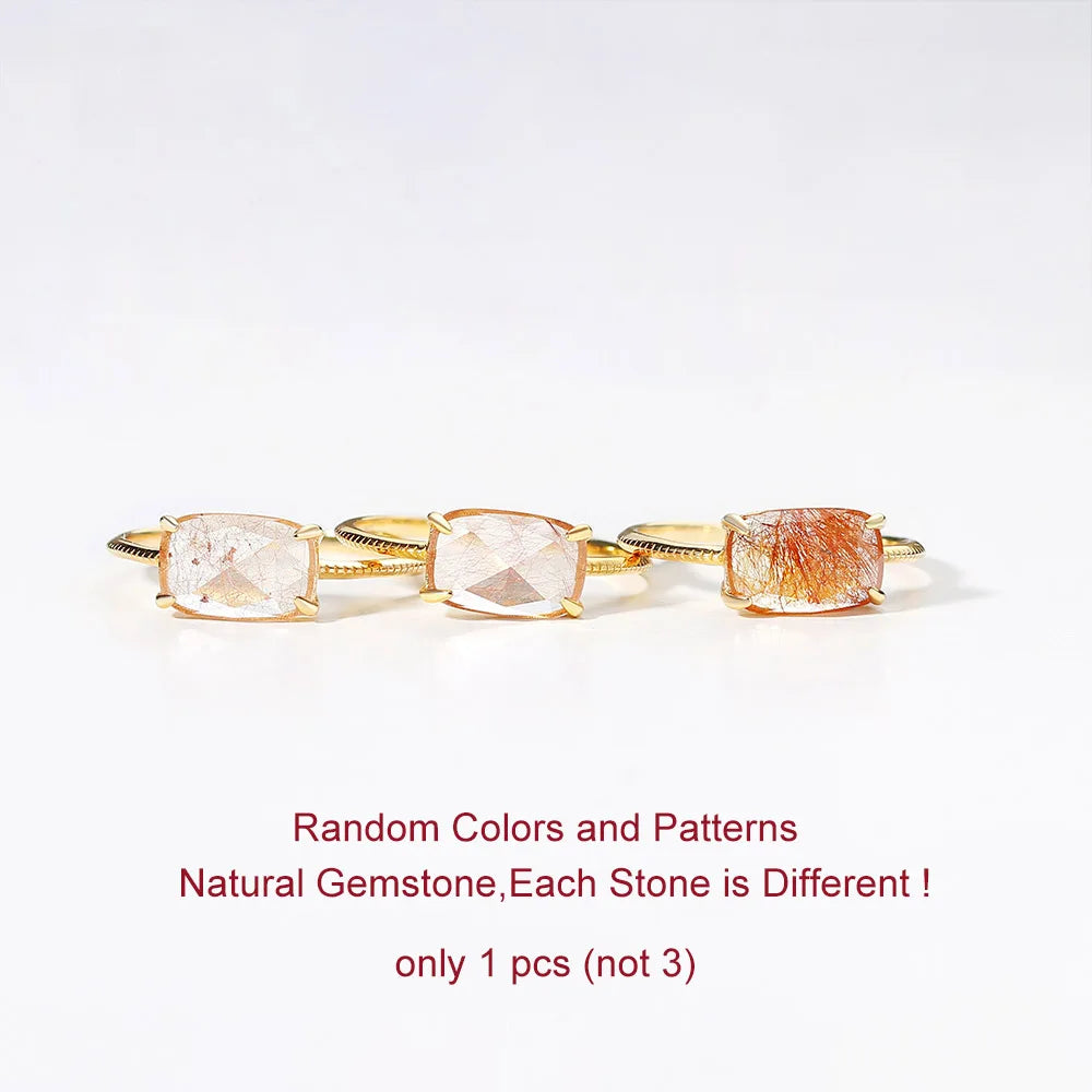 Gold ring with natural gemstones on a white background