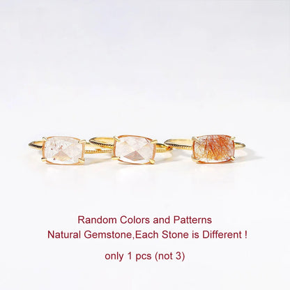 Gold ring with natural gemstones on a white background
