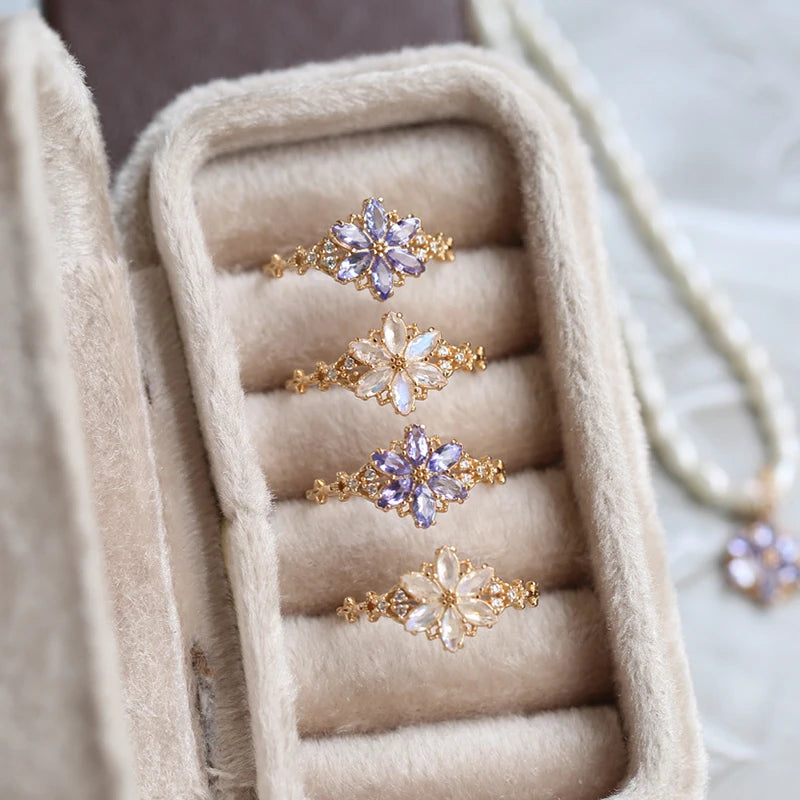Set of gold rings with floral designs in a jewelry box