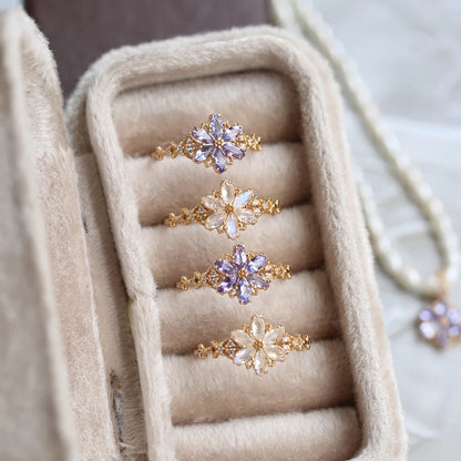 Set of gold rings with floral designs in a jewelry box