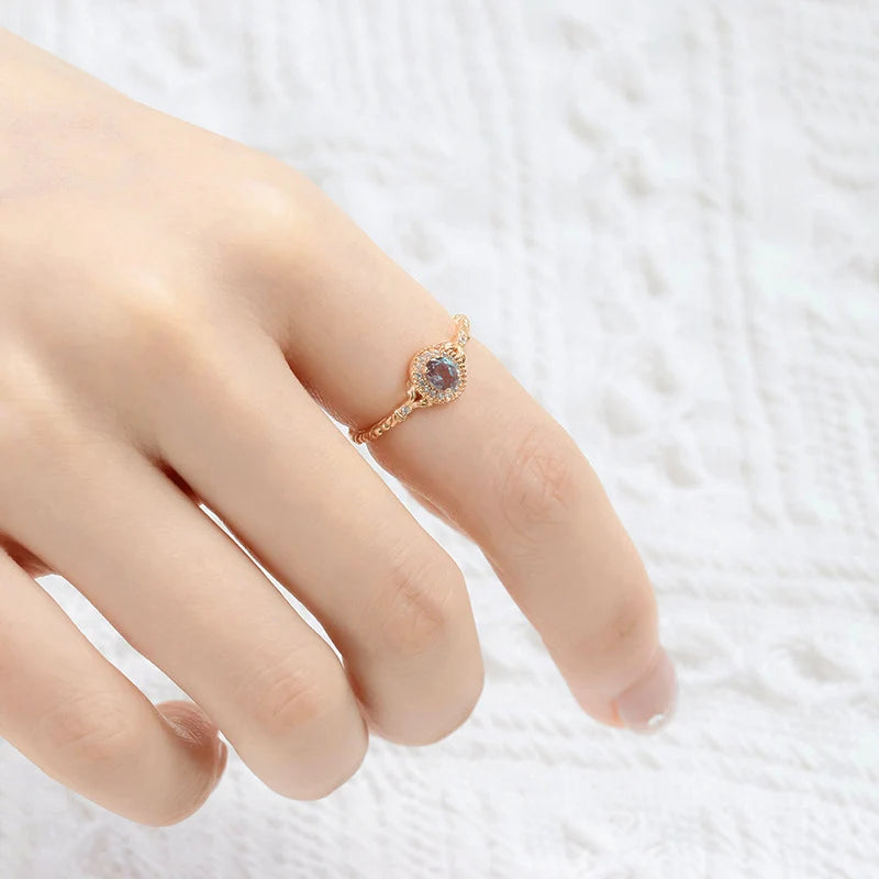 Alexandrite ring worn on finger showing oval color-changing gemstone