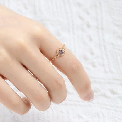 Alexandrite ring worn on finger showing oval color-changing gemstone