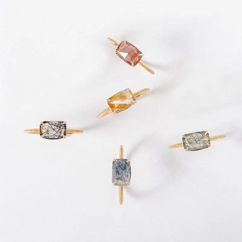 Set of Quartz rings with different colored gemstones on a white background