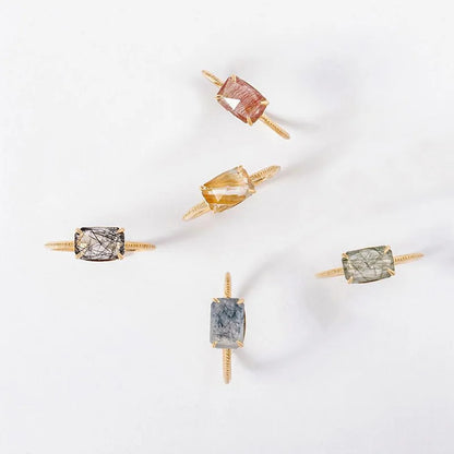 Set of Quartz rings with different colored gemstones on a white background